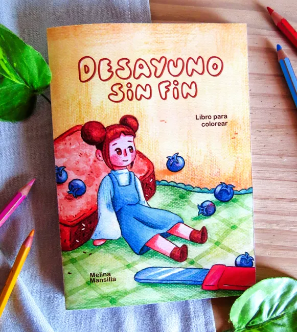 Foto de la portada de Desayuno sin fin, un libro para colorear. Se ve la ilustración de una niña con dos rodetes grandes y vestido azul, apoyada en una tostada y rodeada de arándanos y un cuchillo de manteca.